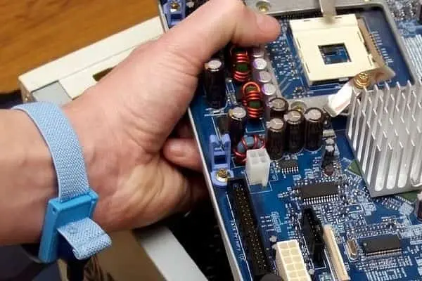 Technician Removing a Computer Motherboard